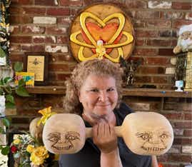 Casey with dumbbells she made with faces of Tweedle Dumb and Tweedle Dumber