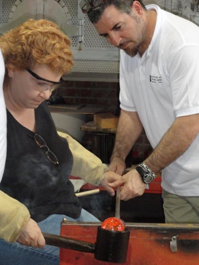 Casey McCaughn taking a glass-blowing lesson in Murano, Italy